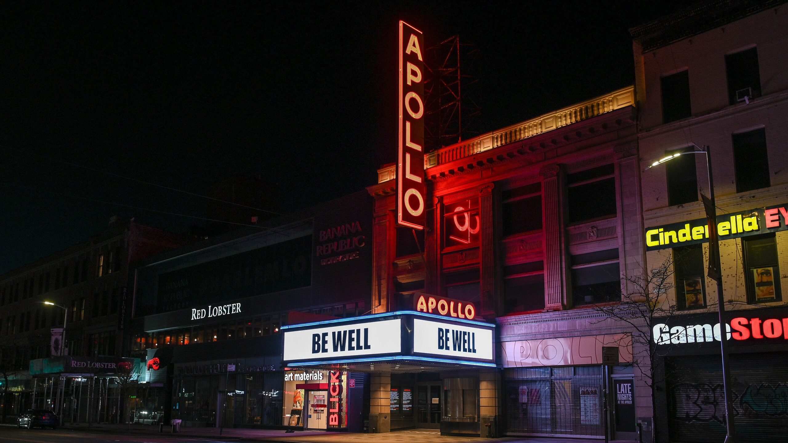 A nighttime view of the Apollo Theater with a marquee that reads “Be Well” as the coronavirus continues to spread across the United States on April 9, 2020 in New York City. Photo: Getty Images Dia Dipasupil